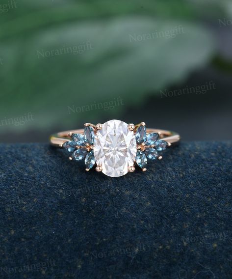 "Oval shaped Moissanite engagement ring Unique rose gold engagement ring Marquise cut Alexandrite Cluster ring Bridal dainty Anniversary ring -----Ring Information----- +Center stone: 6*8mm Moissanite +Color: DEF +Clarity: VS-VVS +Cut type: Oval shaped +Side Stone:  Lab Alexandrite Approx weight: 0.4ctw Metal : Solid 14k/18k yellow gold white gold or rose gold, other metal or gemstones, please contact me! Click on the \"Pin It\" icon if you like this item, Thanks so much! Ring Size All rings are Oval Moisonite Engagement Ring, Silver Alexandrite Engagement Ring, Oval Engagement Ring Colored Stone, Engagement Rings Coloured, Mosinatte Rings, Engagement Rings Blue Stone, Unique Blue Engagement Rings, Blue Moissanite Engagement Ring, Diamond Ring With Gemstone Accents