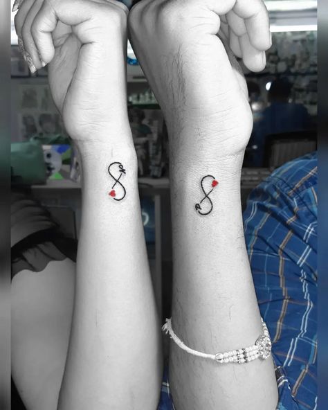 Matching infinity tattoo designs for couples who want to claim their love for each other. Cute, minimalistic couple tattoo ideas. Cute Boyfriend Tattoo Ideas, Couples Mini Tattoos, Gaming Couple Tattoos, Stronger Together Tattoo, Matching Couple Tattoos Minimalist, Cute Matching Couple Tattoos, Wifes Name Tattoo Ideas For Men, Marriage Tattoos Husband Wife, Infinity Matching Tattoos