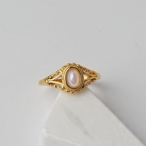 VINTAGE ∙ PEARL ∙ RING Minimalist 14K Gold Ring 💍 The Charm That Inadvertently Radiates This vintage-inspired piece is an eye-catcher luxurious ring. Elegant and prestigious, wear it with pride ✨ 💎 14K gold plated 💎 Stainless Steel ( tarnish-free ) 💎 Unique vintage style Buy 2 or more items and save 60% 🤍 VISIT * OUR * SHOP https://www.etsy.com/ca/shop/EasyJewelsDesign?ref=shop_sugg_market With your support, we can do what we love on a daily basis. Thank you so much for this 💫 Don't hesita Victorian Gold Ring, Vintage Pearl Ring, Pearl Rings Vintage, Cute Engagement Rings, Vintage Style Rings, Dope Jewelry, Vintage Pearl, Funky Jewelry, Jewelry Lookbook