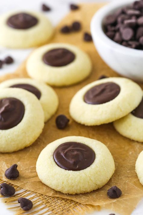 These Chocolate Thumbprint Cookies are a holiday classic! The shortbread-like vanilla cookie base is filled with a silky chocolate ganache for a wonderful cookie you'll come back to each year. Life Love And Sugar, Vanilla Shortbread, Chocolate Thumbprint Cookies, Chocolate Stars, Ganache Filling, Chocolate Ganache Filling, Yummy Biscuits, Cookies With Chocolate, Cookie Base