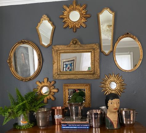 Mirror gallery wall and champagne bucket display featuring finds from European flohmarkts.   In-home design provided by Domestic Provisions.   Sunburst mirror procured by Emilia’s Beautiful Things. #mirrorgallery #mirrorgallerywall #frenchmillineryhead #champagnebuckets #sherwinwilliamspeppercorn Cool Wall Mirrors, Mirror Display Wall, Different Mirrors On Wall, Wall Of Mirrors Bedroom, Mirror Wall Vintage, Gallery Mirror Wall, Vintage Mirrors Wall, Gold Mirror Gallery Wall, Gallery Wall Of Mirrors