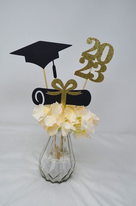 "Set of 3 graduation sticks for centerpiece, DIY decorating! One Set includes a 2023, a diploma/bow and a grad Cap The base container is not included Sizes 2023 approximately 3.3\" x 4.3\" , attached to a 12\" stick Diploma approximately 2.8\"x 5.8\" attached to an 8\" stick Cap approximately 3\"x 6\" attached to a 12\" stick FINISH: Single-sided and double-sided (look at pictures for example) If you want to check out more GRADUATION items click the link: https://www.etsy.com/shop/RedPartyStore? 2023 Graduation Decorations, Graduation Cake Designs, Grad Cake, Graduation Centerpiece, 2023 Graduation, Cake Decorating Ideas, Graduation Cake, Graduation Decorations, Cake Ideas