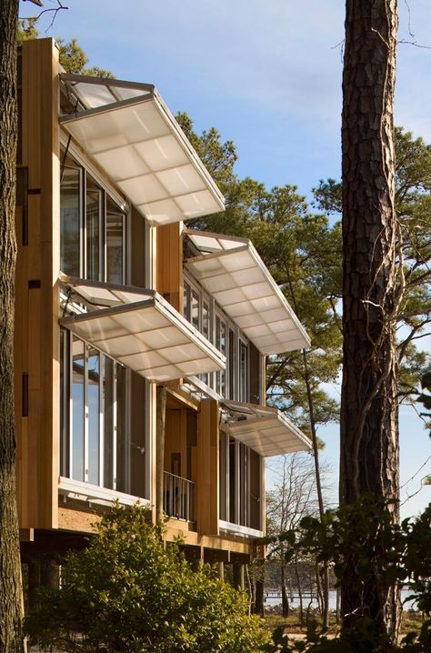 Hangar doors on the west facade can be tuned to the angle of the sun as it changes over the course of the day. Here, they are in the awni... Fasad Design, Butterfly Pavilion, Detail Arsitektur, Solar Solutions, Passive House, Design Exterior, Pergola Shade, Facade Architecture, Facade Design