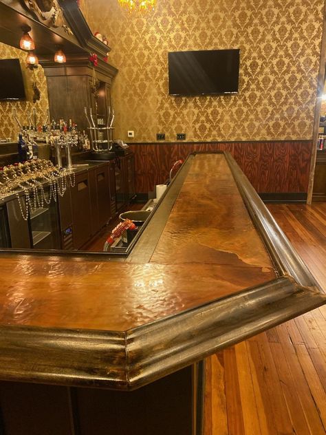 Our copper bar tops are made from scratch right here in Northeast Ohio and are in homes, bars and restaurants across the country. We start out building the base for the bars using cabinet grade plywood. This listing is for Dark Autumn copper. It' will be hand hammered by Skye to give it a nice, durable finish while still being flat so your drinks don't tip over (at least, not because of the copper lol!) Once the copper has been applied we solder and finish out the corners and apply 3 coats of fo Copper Top Bar, Barndominium Bar Ideas, Brass Bar Top, Unique Bar Tops, Basement Speakeasy Home, Speakeasy Home Bar, Bar Top Ideas, Copper Restaurant, Copper Bar Top