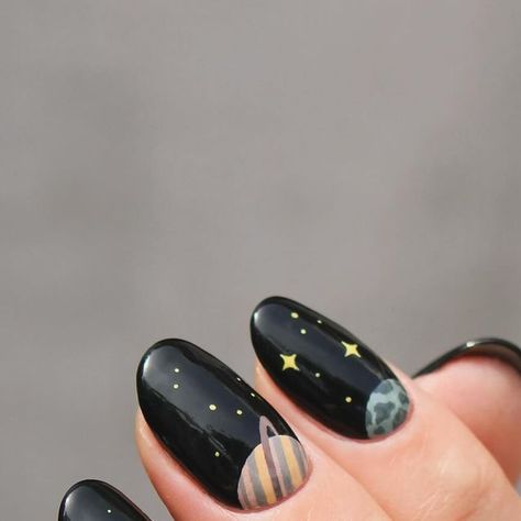 Eva on Instagram: "When in doubt, I bring the planets out. It’s no secret that planet/space manis are my favorite and I’ve done many planet manis over the years. I’ve never done a half moon planet mani, (only actual half moons🌛) so I thought that would be fun!  AND I did both hands! When I do, I only do my other thumb but never a full mani, but this just called for it so I could get all the planets in. (I did want to show a pic of this, but the pictures of it turned out so bad, and my right hand really isn’t all that pretty.)  Really love how it turned out🪐🌍" Planet Inspired Nails, Space Inspired Nails, Solar System Nails, Black Moon Nails, Space Themed Nails, Planet Nail Art, Neutral Nail Art Designs, All The Planets, Planet Nails