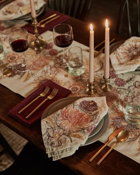 Create an autumnal table setting around fall’s favorite flower: chrysanthemums! Our Mums dinner napkin has a large, coral chrysanthemum embroidered in the center. Three smaller mums frame the blossom, and a Japanese anemone appears at the bottom with two sprigs of golden wheat. This delightful arrangement was designed with fall in mind but can be enjoyed year-round.Measures 20" × 20". Folded measurement 10" × 10". Autumnal Table, Round Table Settings, Dinner Table Set Up, African Daisies, Round Dinner Table, Friendsgiving Dinner Party, Round Table Decor, Simple Table Settings, Japanese Anemone