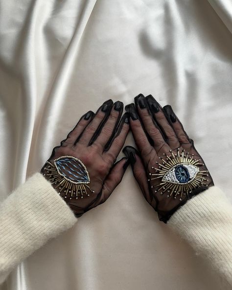 Ready to elevate your spooky season look with just one accessory? 👁️🔮🦇 Our delicate gloves adorned with hand-embroidered eyes that seem to follow your every move, will add an eerie touch to any outfit. Available in short and long styles, they’re the perfect finishing touch for your haunting ensemble. How would you style these gloves for your spooky season look? 👻 Saturn Pisces, Evil Eye Outfit, Embroidery On Black Fabric, Fashion Symbols, Beads Embellishment, Gloves Aesthetic, Eye Accessories, Ropa Upcycling, Tulle Gloves