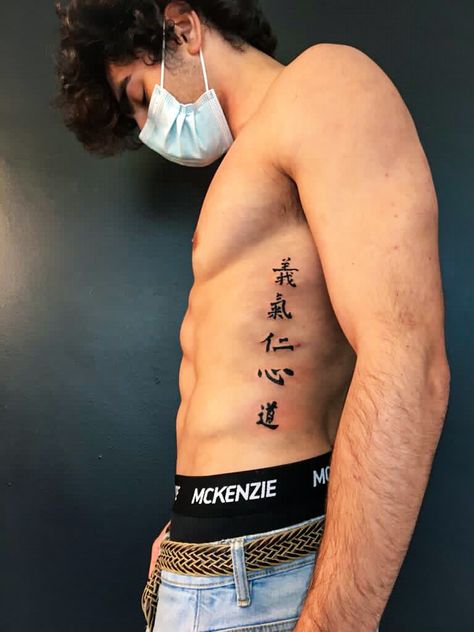 Rib Scar Tattoo, Men’s Tattoos Japanese, Men Tattoo Ideas Japanese, Japanese Word Tattoo Men, Japanese Symbol Forearm Tattoo, Japanese Spine Tattoo For Men, Chest Tattoo Men Ideas Simple, Japanese Letters Tattoo Men, Backbone Tattoo For Men