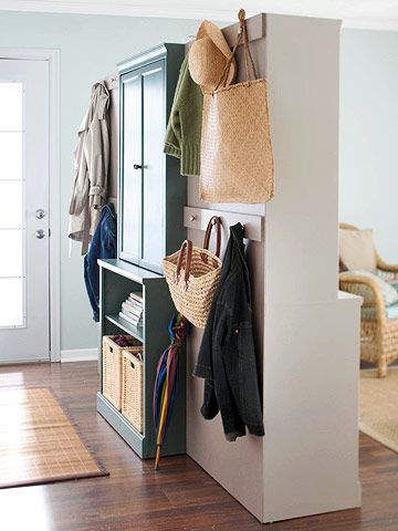 mudroom - Divide and Conquer  If your entry and living room are one and the same, divide the space with easy-to-assemble cabinetry. This nifty closet/room divider neatly organizes living room space into a hardworking entry. There's room for hanging coats and storing gear on one side and attractive display and storage space on the other. Hallway Storage Ideas, Creating An Entryway, Temporary Room Dividers, Metal Room Divider, Fabric Room Dividers, Glass Room Divider, Bamboo Room Divider, Sliding Room Dividers, Hanging Room Dividers