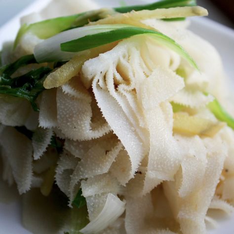 Ginger scallion beef tripe is one of my favorite dim sum dishes. It usually comes in a small dish, and I find it is never enough. I love making tripe at home because I can make and eat as much as I want. I buy beef tripe from a Chinese butcher, and it is important to find tripe that is cleaned well by the butcher. I usually judge it by its color: the whiter the better. Beef tripe is the stomach lining of a cow, and is a general term in the sense that it can be from any one of the three stomach Tripe Recipe, Tripe Recipes, Homemade Dumplings Recipe, Island Recipes, Beef Tripe, Dim Sum Recipes, Collagen Recipes, Authentic Asian Recipes, Chinese Dessert