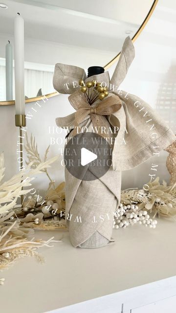 Wrap A Wine Bottle In A Tea Towel, Champagne Bottle Gift Wrapping Ideas, Gift Wrapping With Tea Towels, Tea Towel Wine Bottle Wrap, Wine Bottle Wrapped In Tea Towel, Gift Wrap Liquor Bottle Ideas, Wrap A Wine Bottle In A Dish Towel, Tea Towel Wrapped Gift, Wrapping A Wine Bottle In A Tea Towel