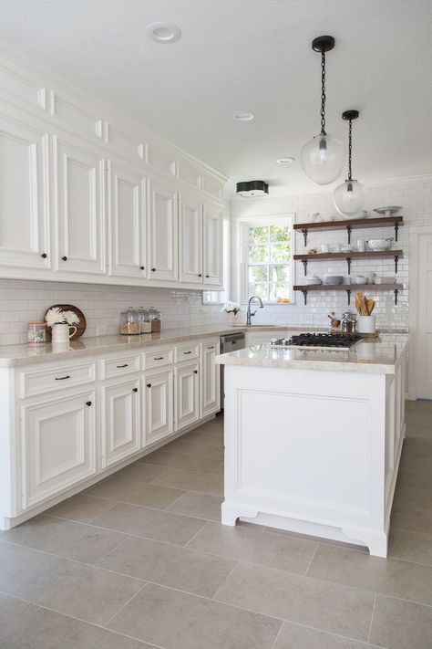 Beautiful Farmhouse kitchen remodel - used to be dark with oak cabinets, added a box and paneled it above the cabinets to give an illusion of taller cabinets, tiled wall, open shelving, Taj Mahal quartzite countertops, seeded glass pendant lights Carla Aston, Taj Mahal Quartzite Countertops, Farmhouse Kitchen Colors, Kitchen Floor Tiles Ideas, Farmhouse Kitchen Remodel, Herringbone Backsplash, Classic Kitchen, Versace Home, Kitchen Floor Tile