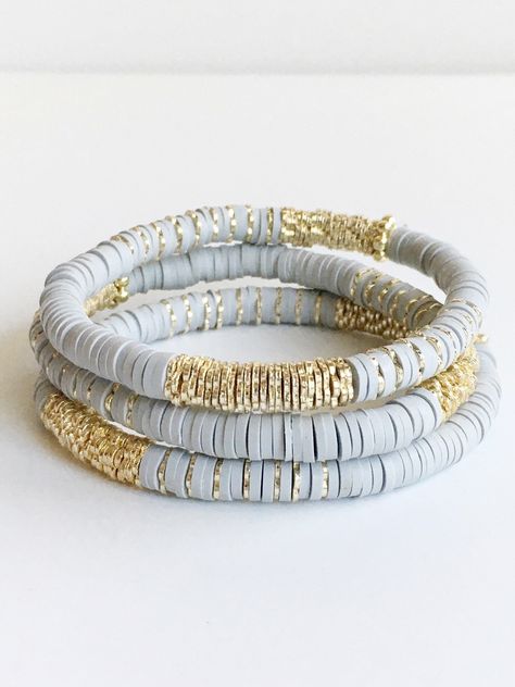 Light Gray Confetti and Gold Beaded Bracelet ⟡ all items are designed and handcrafted in our studio ⟡ Hand strung vinyl and 14kt gold plated beads on stretch material. Fun, lightweight, colorful bracelets - perfect for year round. A combination of polymer clay vinyl beads and 14kt gold plated beads. Each bracelet is stretchable and easily layers with other bracelets or a watch. The bracelet cannot be opened, and need to fit over your hand. Treat yourself to a fun new bracelet! These bracelets ar Polymer Clay Beaded Bracelet, Clay Beads Jewelry Making Tools, Clay Bead Patterns Bracelet, Clay Bead Bracelet Ideas Adults, Gray Clay Bead Bracelet, New Year Bracelet, Clay Bead Bracelet Ideas Neutral Colors, Trendy Bracelets 2024, Polymer Clay Bead Jewelry