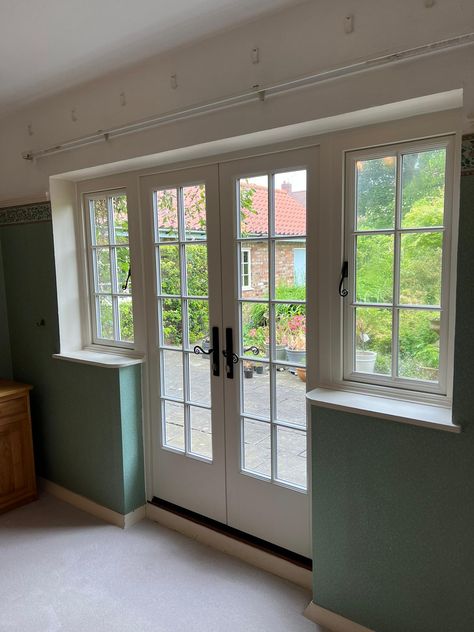 White french doors on the inside of a house with casement windows either side. Kitchen With French Doors To Patio, Door With Window Above, Double Casement Windows, French Casement Windows, Ikea Vases, White French Doors, External French Doors, French Patio Doors, Casement Window