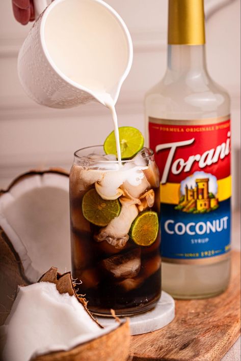 Enjoy the creamy coconut flavor of Classic Dirty Soda: soda, Torani Coconut Syrup, limes, and half-and-half for a delightful burst of flavor. Soda Drinks Recipes, Torani Syrup Recipes, Snow Cones Recipes, Torani Syrup, Soda Floats, Iced Chai Latte, Syrup Recipes, Coffee Soda, Coconut Syrup