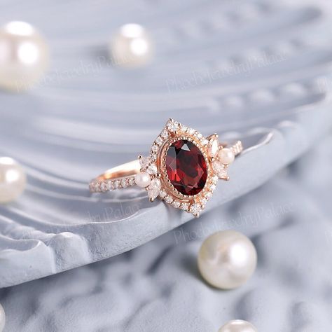 Vintage Oval Shaped Garnet and Pearl Engagement Ring Art Deco Ruby Filigree Solid Gold Wedding Ring Unique Birthstone Ring Anniversary Gift PRODUCT SUMMARY Metal Type: yellow, white or rose solid 14 or 18k gold. Size: All sizes are available, contact me if they do not contain the size you want in the drop-down menu. ☪☪Engagement ring ⚜Center Stone - Garnet Cut - Oval Size - 7x5mm ⚜Side Stone - Moissanite Cut - Round Weight - 0.33ct Clarity - SI-VS Color- G-H ⚜Band width - 1.8mm This ring work wi Unconventional Wedding Rings, Pearl Wedding Bands, Garnet And Pearl, Ruby Wedding Rings, Pretty Engagement Rings, Wedding Ring Unique, Garnet Engagement Ring, Engagement Ring Art Deco, Pearl Engagement Ring