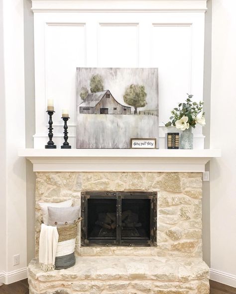 Tan, white and gray woven basket is placed on the hearth of a beige painted stone fireplace. Gray artwork is perched on the ivory fireplace mantel in front of white decorative molding. Art Above Fireplace, Mosaic Tile Fireplace, Above Fireplace Ideas, Fireplace And Mantle, White Fireplace Mantels, Painted Stone Fireplace, Gray Artwork, White Mantle, Grey Fireplace