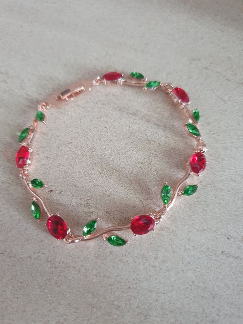 Elegant flower bracelet with Ruby red flower and green leaf gem detailing. Stephen Sanchez, Rakhi Design, Red Jewelry, Wedding Jewelry Bracelets, Elegant Red, Elegant Flowers, Green Flower, Flower Bracelet, Green And Red