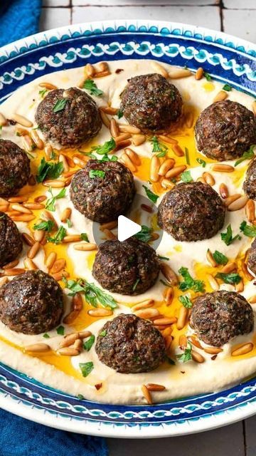 Suzy- Mediterranean Food & Diet on Instagram: "Meatballs & Hummus 😋Recipe👇  Have you ever thought of trying baked meatballs over hummus?   Most people think spaghetti and meatballs, but if you’re up for something new and best level delicious, MAKE THIS easy dinner!   You’ll love the Middle Eastern seasoning in these meatballs! it’s basically what I use for my kofteh kebabs-allspice, cardamom, paprika, sumac, onions, garlic, parsley! Yes, these kofta meatballs are a flavor party!!🎊   Serve them over creamy dreamy hummus with a drizzle of good olive oil and some pita bread and watch how quickly people eat it!   Sure, this can make the perfect mezzo or appetizer, but in my house, this is the perfect protein packed meal / dinner! No one is ever mad when I make this easy Lebanese style recip Lebanese Appetizers Parties, Lebanese Party Food, Lebanese Dinner Party, Suzy Mediterranean, Middle Eastern Meatballs, Herb Couscous, Hummus Cup, Kofta Meatballs, Mediterranean Meatballs