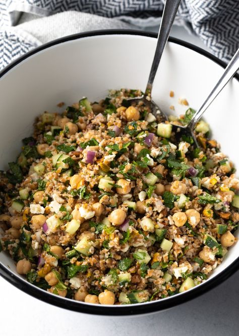 Large white bowl filled with bulgar wheat, veggies, and feta salad. Two metal salad spoons are in the bowl as well. Bulgar Salads, Wheat Salad Recipes, French Press Cocktails, Bulgar Wheat Salad, Jennifer Aniston Salad Recipe, Jennifer Aniston Salad, Aniston Salad, Tequila Recipes, Wheat Salad