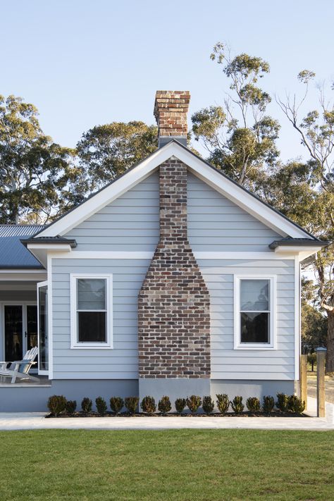 Recycled bricks provide a rustic contract to this home's chic exterior cladding, painted in Dulux timeless grey. Chimney In Front Of House Exterior, Dulux Timeless, Hampton Exterior, House Exterior Cladding, Hampton Style House, Weatherboard Exterior, Hamptons House Exterior, Boston House, Hamptons Homes