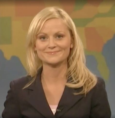 A profile screenshot of Amy Poehler on SNL's Weekend Update. She is wearing a grey blazer and the U.S. portion of the world map serves as her background. 2000s Tv Shows, Blades Of Glory, Secret World Of Arrietty, Horton Hears A Who, Weekend Update, The Secret World, Amy Poehler, Girls Club, Snl