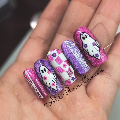 The nails alternating in pink and purple cat eye gel polish. The thumbs and ring finger have white ghosts with alternating flowers. The middle has a white waving checkered design. The pointer and pinky are split web designs. All nails have a glossy top coat finish. All nails have a builder gel layer. Available in different shapes and lengths. **Please measure your nails for the XXL length and select "XXL Custom Sizes" then send me your measurements.** Each order comes with a nail prep kit which includes nail glue, nail adhesive tabs, nail file, buffer, cuticle stick, alcohol wipes, and instructions. Please don't hesitate to ask me any questions. Cute Purple Halloween Nails, Halloween Nails Colorful, Pink And Purple Halloween Nails, Purple Jelly Nails Acrylic, Cute Halloween Nails Pink, Retro Halloween Nails, Bright Halloween Nails, Halloween Birthday Nails, Funky Fall Nails