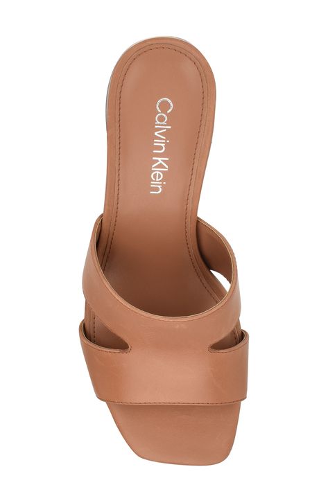 Logo-engraved heel hardware lends sleek detail to a modern cutout sandal finished with a chic square toe. 2" heel Leather upper/synthetic lining and sole Imported Sandal Women, Womens Sandals, Calvin Klein, Leather Upper, Size 7, Nordstrom, Sleek, Sandals, Square