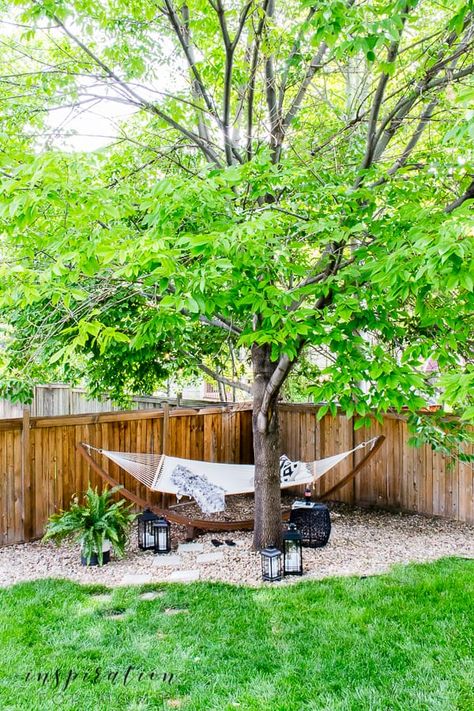 Turn an area of your yard into a backyard hammock oasis escape. It's the perfect way to enjoy the lazy days of summer. #summeroutdoordecor #hammocklife Hammock In Corner Of Yard, Hammock Corner Backyards, Hammock Nook Outdoor, Dirt Area In Backyard, Hammock Ideas Backyard Trees, Tree Hammock Ideas, Hammock Area Backyard, Hoa Friendly Backyard, Hammock Under Tree