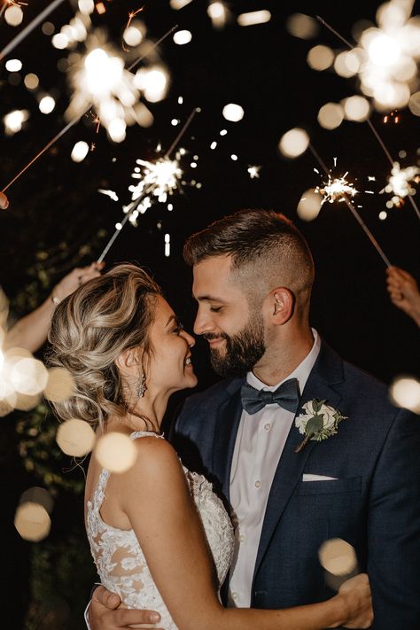 Husband and Wife on wedding day hugging with bright sparklers surrounding them Sparklers Wedding Pictures, Wedding Sparklers Photos, Sparkler Exit Wedding, Wedding Group Photos, Wedding Photo List, Wedding Fotos, Buffalo Wedding, Wedding Exit, Wedding Portrait Poses