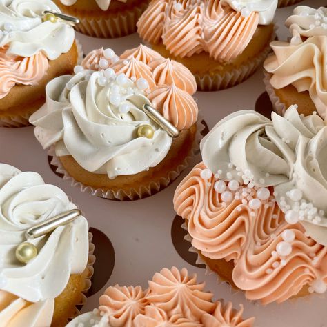 Peach and ivory cupcakes, decorated with white and gold sugar pearls Peach And Gold Cake Birthday, Peach Colored Cupcakes, Peach Color Cupcakes, Ivory Cupcakes, Peach Icing, Coral Cupcakes, Cupcake Icing Designs, Peach Items, Bday Brunch