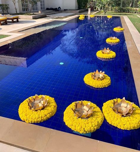 15 Unique Ways to Decorate the Pool & Poolside Area at Your Wedding Venue | ShaadiSaga Haldi Decor Poolside, Poolside Mehendi Decor, Poolside Haldi Decor, Pool Side Haldi Decor, Haldi Entry, Marigold Flower Garland, Swimming Pool Decorations, Color Home Decor, Haldi Decor