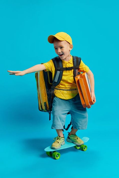 Child in yellow outfit and cap, riding skateboard, carrying packages and backpack, dreaming of being delivery person. stock photography Photography Person, Riding Skateboard, Backpack Photography, Person Photo, Vector Food, Yellow Outfit, Put On, Stock Photography, Carry On