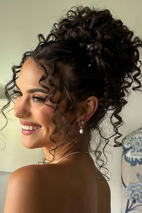 20 curly hair updos ideas you will love 3 Curly Upstyles For Long Hair, Pretty Updos For Medium Hair Wedding, Short Hair Curly Updo Bridesmaid, Hairstyles For Curly Hair For A Wedding, Up Due Hairstyles For Curly Hair, Classy Bun Wedding Hair, Curly Bun Updo Prom, Brown Curly Wedding Hair, Cute Easy Updos For Curly Hair