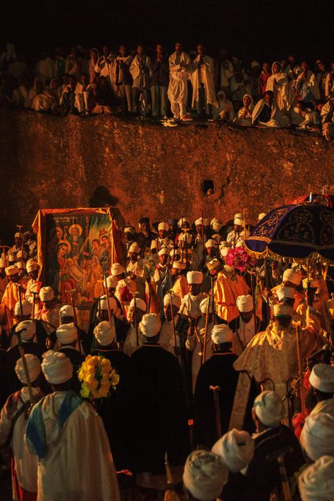 Ethiopian Orthodox Christmas, known as *Genna*, is celebrated with profound devotion in Lalibela, Ethiopia. Pilgrims gather in this holy city, famous for its rock-hewn churches, to participate in all-night prayers, hymns, and liturgical services. The celebration is marked by traditional chants, candlelight processions, and a deep sense of spiritual reverence, creating a truly awe-inspiring atmosphere. #Orthodoxtewahdo #Orthodoxchristmas #Sacredlalibela Ethiopia Orthodox Wallpaper, Ethiopian Orthodox Wallpaper, Ethiopian Orthodox Church Pictures, Ethiopian Iconography, Habesha Aesthetic, Ethiopian Christmas, Ethiopia Aesthetic, Orthodox Aesthetic, Planetary Defense