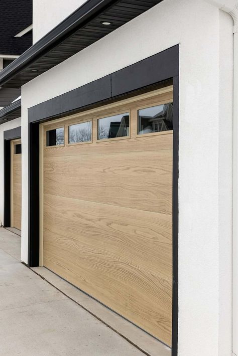 Light Wood Garage Doors White House, Black And White House Exterior With Wood Garage Door, Black White Wood Exterior House, Modern Garage Door Styles, Light Wood Garage Door, Modern Wood Garage Door, Modern Farmhouse Garage Door, Modern Garage Doors Ideas, Garage Door Exterior