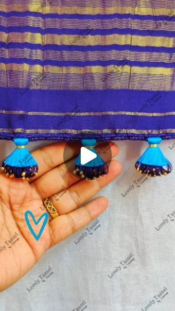 Lovely Tassel Work by Lavanya on Instagram: "Designer Double Step Tassel Work💙Notes👇
•8 Strands of silk thread for Crochet base
•Crochet Needle no. 9
•4 chain base
•6 strands of silk thread knotted at end(approx 4.5 feet length)
•wrapped 22 times using one inch thick board by inserting one small bead each time in 4 chain gap
•knotted using 2 strands of cotton thread
•160 strands of silk thread glued at tip and tied second tassel, using 2 strands of zari thread
• trimmed to half length both the sides separately
•Gap between each tassel 2 inches
•Happy Tasseling 😊 Thank you 🙏
.
.
.
#lovelytassel #saree #sareetassel 
#sareekuchulu #sareekuchu #kuchulu 
#tassels #kuchu #weddingsarees 
#bridalsarees #insta 
#indianwomenfashion #threadwork 
#diy #sareepalluhangings #sareetassels 
#handcrafte Kuchu Designs Saree, Saree Kuchulu, Saree Kuchu Design, Crochet Base, Saree Kuchu New Designs, Tassels Designs, Work Notes, Kuchu Designs, Saree Tassels Designs