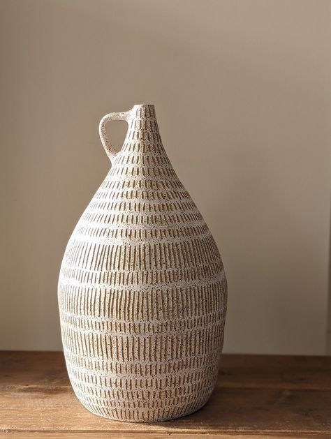 This handmade vase has been lovingly built using coils from a beautiful speckled stoneware clay. Inspired by natural forms from nature it is decorated with a soft white slip and then carved freehand using sgrafitto technique to produce the patterns. This is a beautiful statement piece for your home. This vase is approximately 38cm H. Pottery Decorating Techniques, Ceramic Pottery Vase Ideas, Handbuilt Ceramic Vases, Pottery Vessels Ideas, Slip Decorated Pottery, Ceramic Vase Handmade, Coil Built Ceramics, Sgrafitto Ceramics Patterns, Organic Ceramic Vase