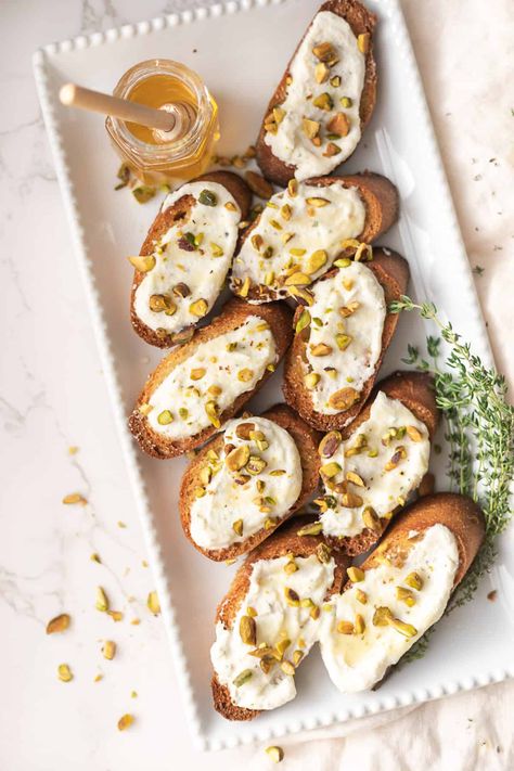 Whipped Ricotta Crostini with Honey and Pistachios - CC's Table | Easy Recipes for Entertaining Whipped Ricotta Peach Crostini, Whipped Ricotta Crostini, Fun Appetizers, Ricotta Crostini, Recipes For Entertaining, Whipped Ricotta, Fig Jam, Food Board, Christmas Appetizers