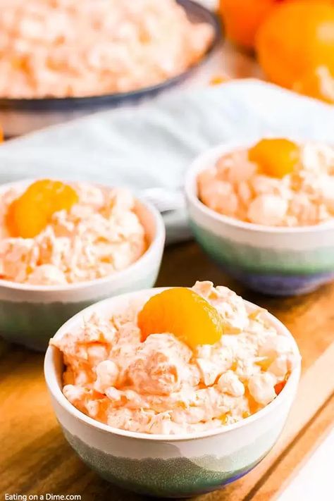 Mandarin orange jello salad recipe with cottage cheese has just 6 ingredients and takes minutes to prepare. Whipped topping, jello, manderine and more make this salad delicious and fluffy. Enjoy this tropical salad with pineapple and cool whip. #eatingonadime #mandarinorangejellosaladrecipe #mandarinpineapple Jello With Oranges, Green Jello Salad With Cottage Cheese, Watergate Salad With Cottage Cheese, Orange Watergate Salad, Mandarin Orange Salad Jello Cool Whip, Cool Whip Salad Recipes, Orange Fluff Salad Mandarin, Cool Whip Salads, Jello Cottage Cheese Salad