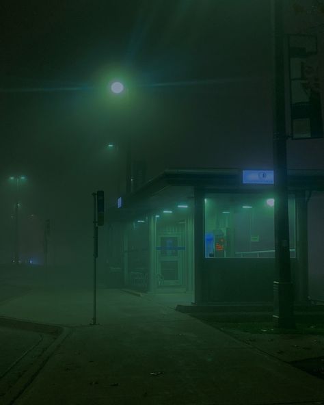 This shows a bus stop that’s lit in an eerie green foggy way. Green Foggy Aesthetic, Dark Foggy Aesthetic City, Foggy Nights Aesthetic, Dark City Photography, Foggy Green Aesthetic, Foggy City Night, Foggy Liminal Space, Foggy Aesthetic City, Foggy City Aesthetic