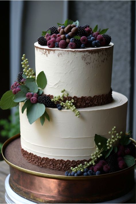 A two-tiered rustic wedding cake with a textured buttercream frosting on a white cake stand. The top tier is adorned with fresh berries and herbs, while the bottom tier is decorated with a rustic burlap ribbon. The cake is made with a rich chocolate cake recipe with a hint of espresso for added depth, giving it an elegant yet rustic look. Rich Chocolate Cake Recipe, Two Tiered Cake, Textured Buttercream, Chocolate Wedding, Wedding Chocolate, Berry Cake, Chocolate Wedding Cake, Rich Chocolate Cake