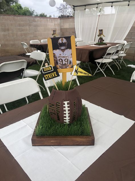 Football centerpieces Football Senior Serve Table Ideas, Football Treat Table, Football Sports Banquet, Football Birthday Party Centerpieces, Football Theme Party Centerpieces, Graduation Football Centerpieces, Football Birthday Centerpieces, Football Theme Centerpiece Ideas, Football Theme Graduation Party Ideas