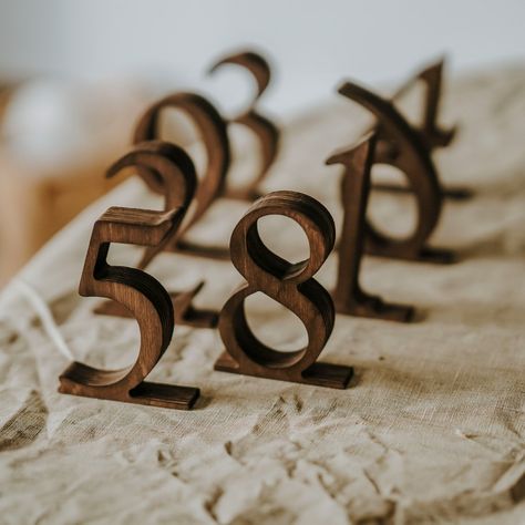 Rustic Wooden Wedding Table Numbers Add elegance and rustic charm to your wedding with our Wooden Wedding Table Numbers. Perfect for rustic-themed weddings, these custom wooden signs are not just functional but also beautifully designed to complement your table decor. They leave a memorable impression on your guests with their high-quality craftsmanship. Materials: Crafted from durable plywood in rustic brown and black, and sleek ashwood in white, our table numbers are built to last and look gre Wedding Table Number Ideas Rustic, Wedding Table Numbers Elegant, Fall Table Numbers Wedding, Wedding Table Numbers Unique, Farmhouse Table Wedding Decor, Farmhouse Table Wedding, Rustic Table Numbers Wedding, Wooden Wedding Table Numbers, Table Wedding Decorations