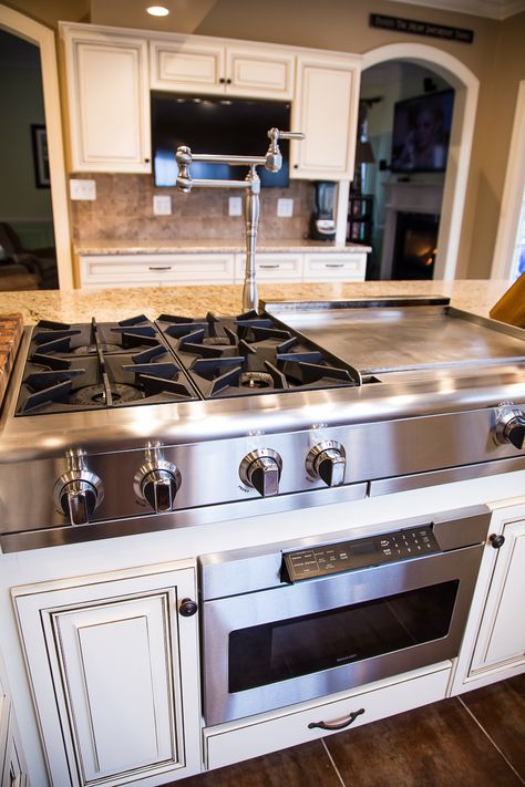 This remarkable kitchen has maple cabinets with presidential doors. A wall was removed to make way for the large island. The island seats 12 or more and features a hibachi cooktop and range hood. See more at: http://www.kitchensaver.com/kitchen/timonium-md/ Kitchen Island With Cooktop, Island With Stove, Kitchen Island With Stove, Contemporary Kitchen Island Lighting, Unique Kitchen Design, Kitchen Stove, Kitchen Island Design, Kitchen Island Lighting, Unique Kitchen