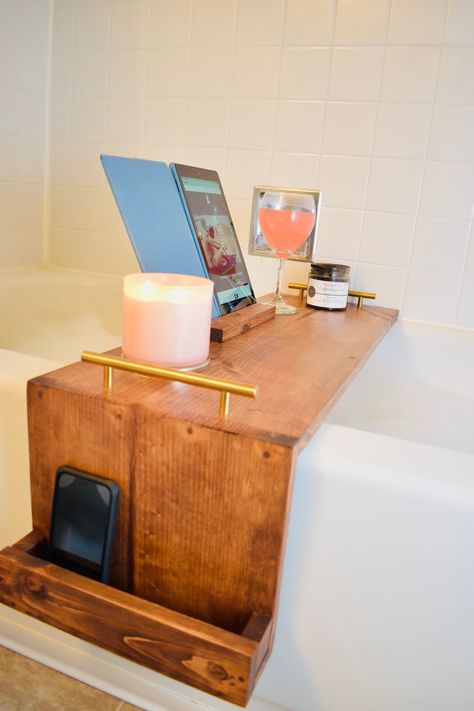 Unique wooden bathtub tray with side attached wooden holder which is perfect for cellphone storage, and snacks while you bathe.  Attached to the top is a wooden stand perfect for your book or iPad.  Information needed to complete the tray is the faucet location. While standing facing the wall - is your faucet on the left or right side? Measurements are as follows: Width of Tray is 11 1/8inches Back stand is 11 1/8 inches wide and 6 1/2 inches tall Side Holder extends down 9 inches Bathtub Book Holder, Bathtub Board, Wood Bath Tray, Bathtub Shelf, Bathtub Ideas, Wooden Bathtub, Diy Bathtub, Bath Board, Tub Tray