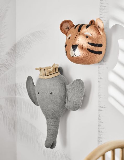 A friendly face makes this tiger a rawr-y cute finishing touch in the nursery, kid's room or playroom. Carefully handmade of felted wool, this sweet, striped pal keeps a close eye on your little cub with fuzzy round ears and delicate embroidered features.   • Handmade  • 100% felted wool with embroidered details  • Due to its handmade nature, each item will vary slightly  • Spot clean only  • Made in Nepal Felt Tiger Animal Head Wall Decor Boy Nursery Safari, Baby Animal Nursery Theme, Twin Nursery Decor, Nursery Animal Heads, Felt Tiger, Magical Nursery, Felt Elephant, Animal Head Wall Decor, Head Wall Decor