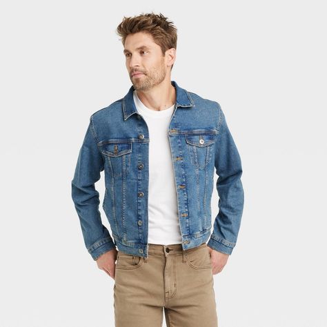 This Denim Trucker Jacket from Goodfellow & Co™ is the perfect statement piece to throw on over any of your off-duty ensembles. Made from heavyweight cotton with a hint of spandex, this mid-wash blue jacket has a collared neckline with a full-length button-down front, paneled construction with stitching details and long sleeves with buttoned cuffs. It's tailored in a standard fit that hits at the waist for comfortable wear, while the buttoned flap pockets on the chest and side welt pockets compl Blue Jean Jacket Outfits Men, Men Jean Jacket, Jean Jacket Outfits Men, Blue Jeans Outfit Men, Wishlist Ideas, Blue Jean Outfits, Rodeo Outfits, Outfits Hombre, Denim Trucker Jacket