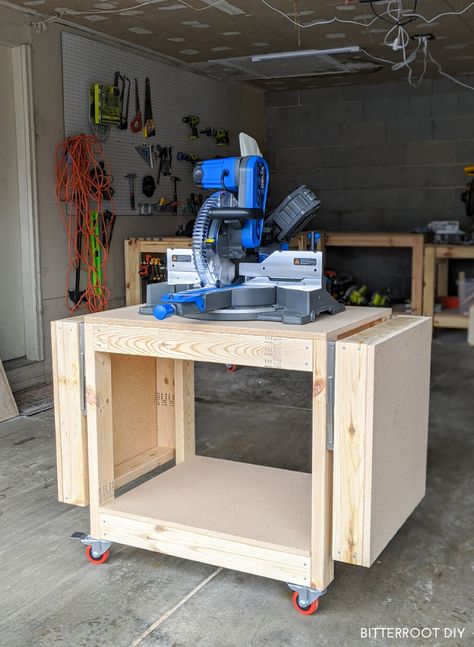 Build this DIY mobile miter saw stand with collapsible wings with free plans from Bitterroot DIY.     #woodworking #shoporganization #shoptips #woodshop #workshop #mitersawstand #workbench Diy Miter Saw Stand, Woodworking Plans Storage, Miter Saw Stand, Miter Saw Table, Mitre Saw Stand, Table Saw Stand, Saw Stand, Workbench Plans Diy, Diy Table Saw