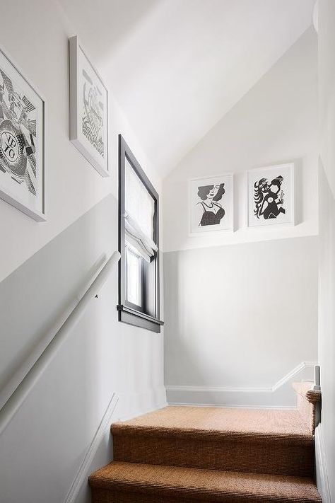 Two-toned walls design a staircase with artistic black and white wall art in white frames. 1920 Home Remodel, Stairway Paint Ideas, Staircase Wall Painting Ideas, Hallway Wall Colors, Half Painted Walls, Stairwell Wall, Grey Hallway, Walls Design, Two Tone Walls